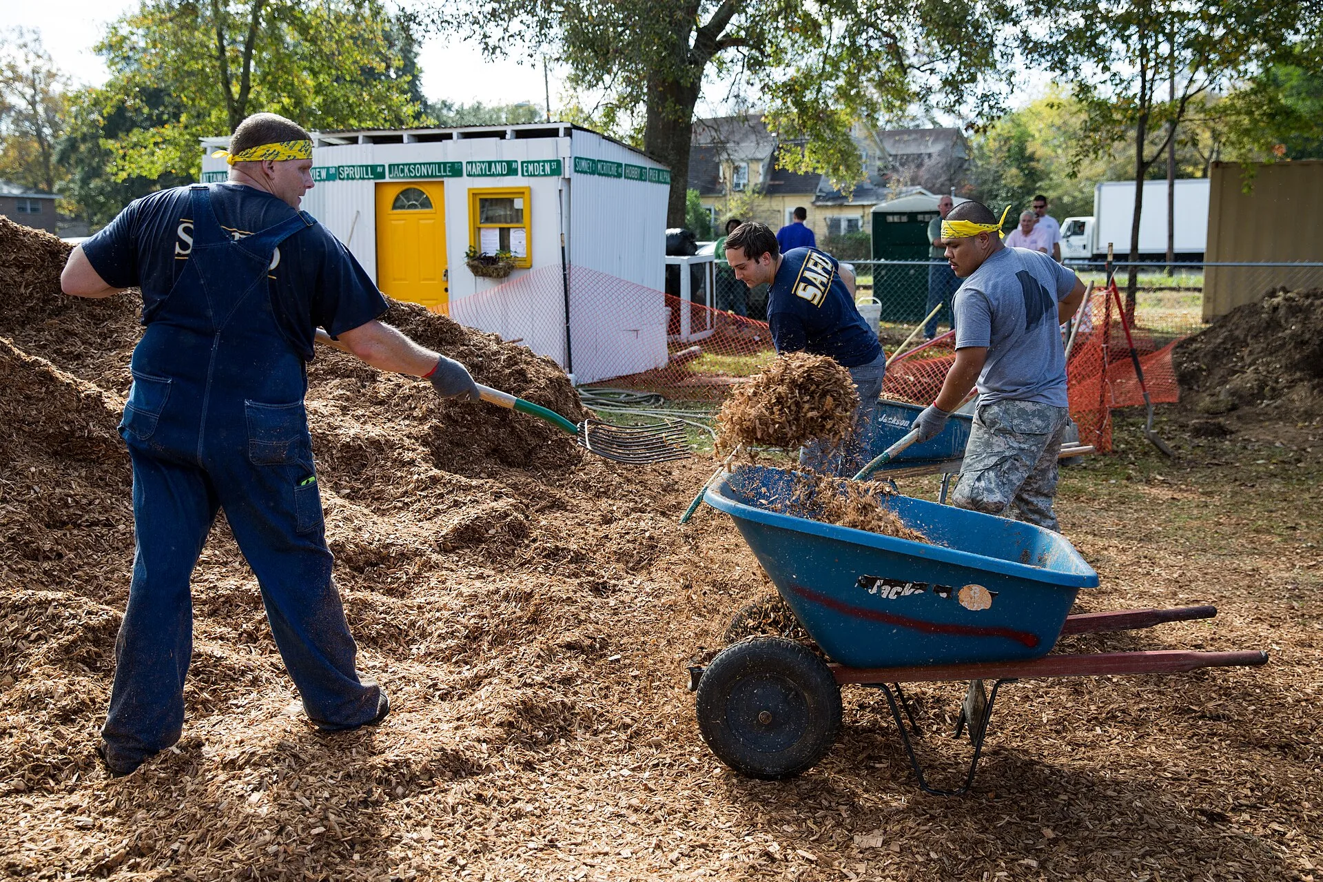 Neighbours and volunteers building a community playground together